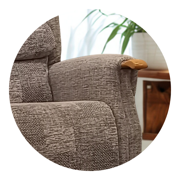 Close-up of a chair's upholstered armrest with a visible wooden knuckle accent at the front.