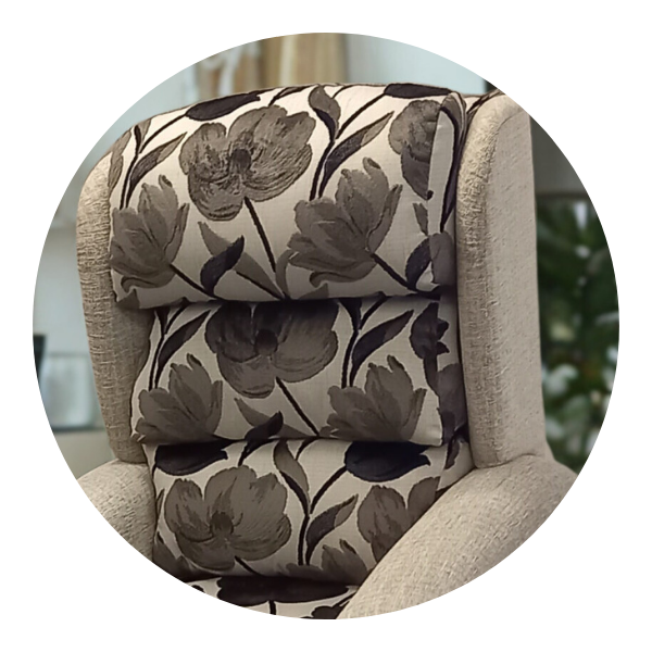 Close-up of a chair's backrest featuring a plush, multi-cushioned waterfall design in a floral pattern.