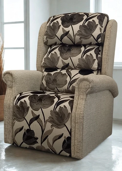 A rise and recline chair with a floral patterned back and seat, combined with beige plain fabric on the frame and scroll arms.