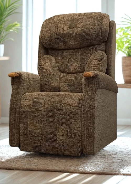 A brown patterned fabric rise and recline chair with padded scroll arms and a waterfall back, part of The Castle Range.